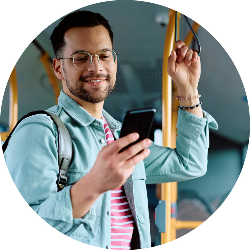 Man on the bus accessing QuickBooks app on mobile phone for on-the-go tools