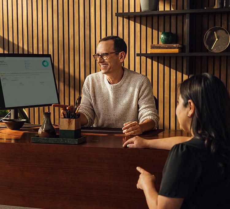 A person sitting at a desk with a laptop computer.