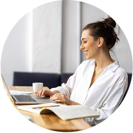 A person sitting at a desk with a laptop computer.