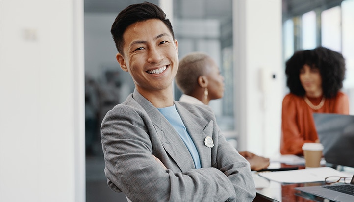 A person in a suit and tie smiles.