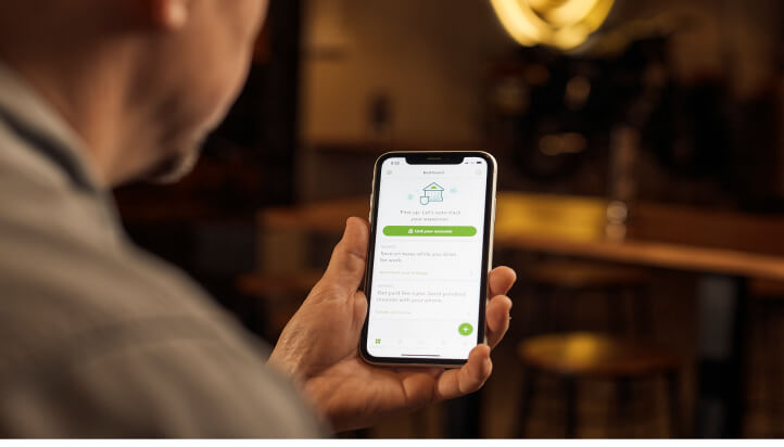 Person using QuickBooks on smartphone to manage expenses