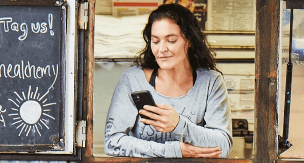 Small business owner using QuickBooks after getting her small business rebate.