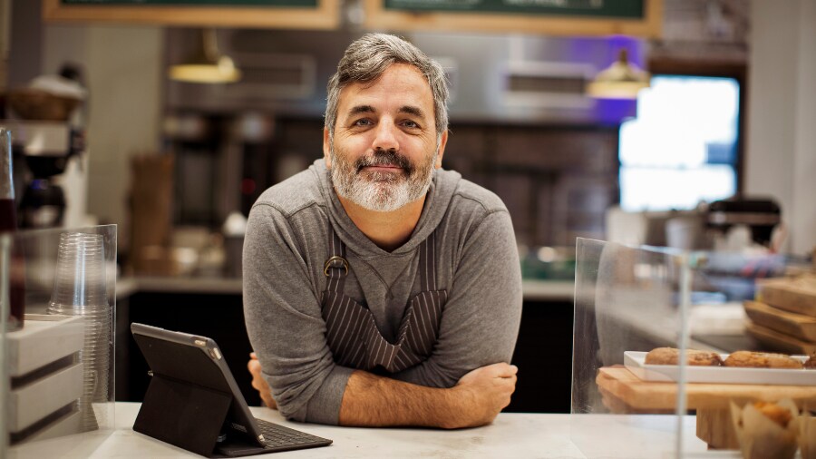 A man sitting at a counter looking at the camera 