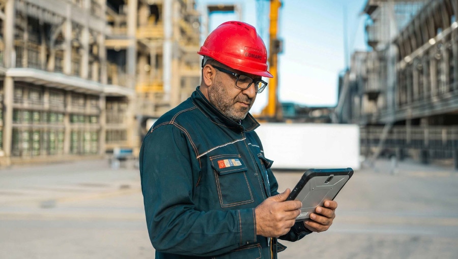 Industrial worker using digital tablet onsite