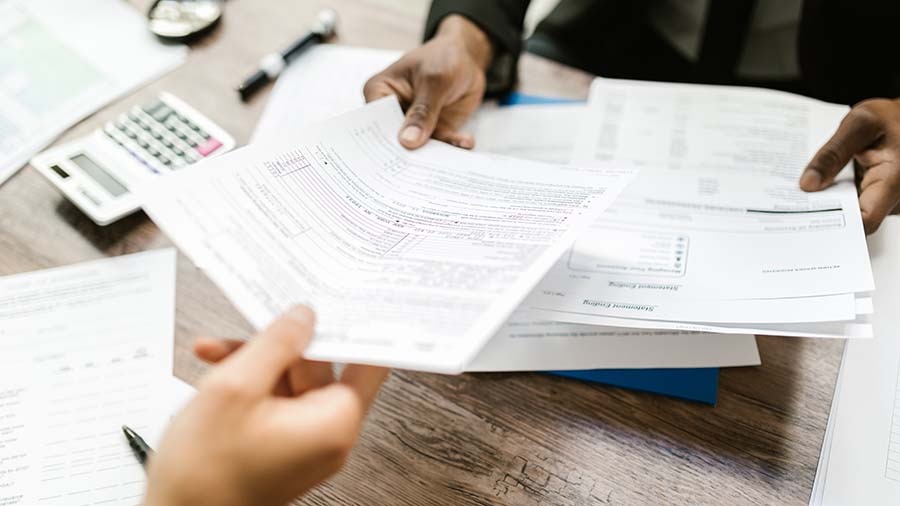 Accountant handing tax form to client