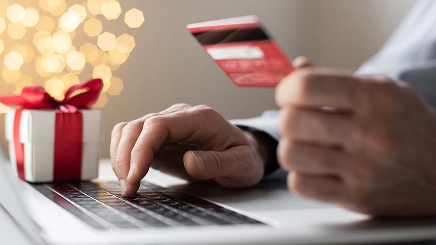 Online shopper using a gift card for his Christmas gifts