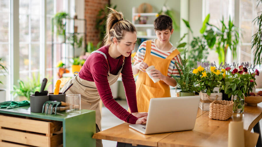 A person and a person standing in a kitchen.