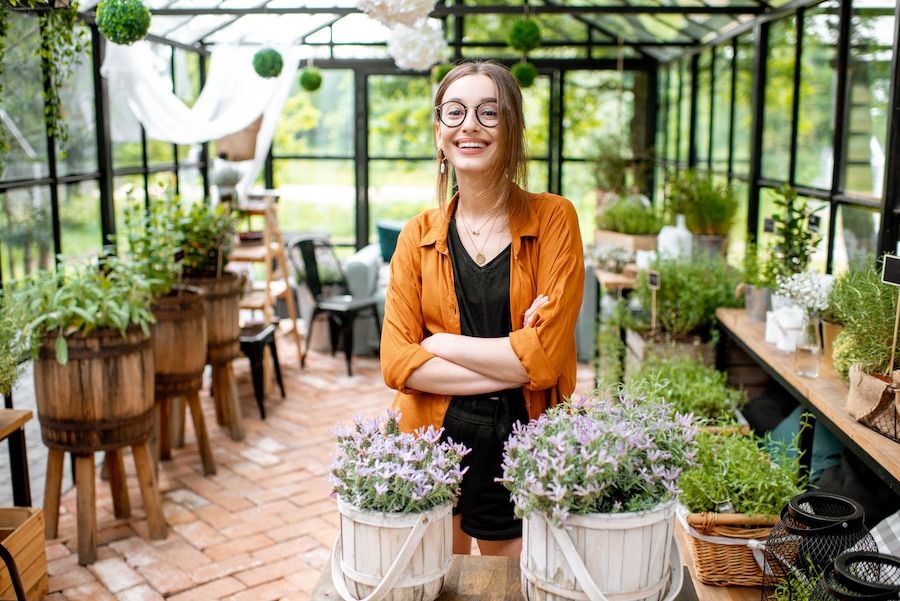 Entrepreneur standing in her green house