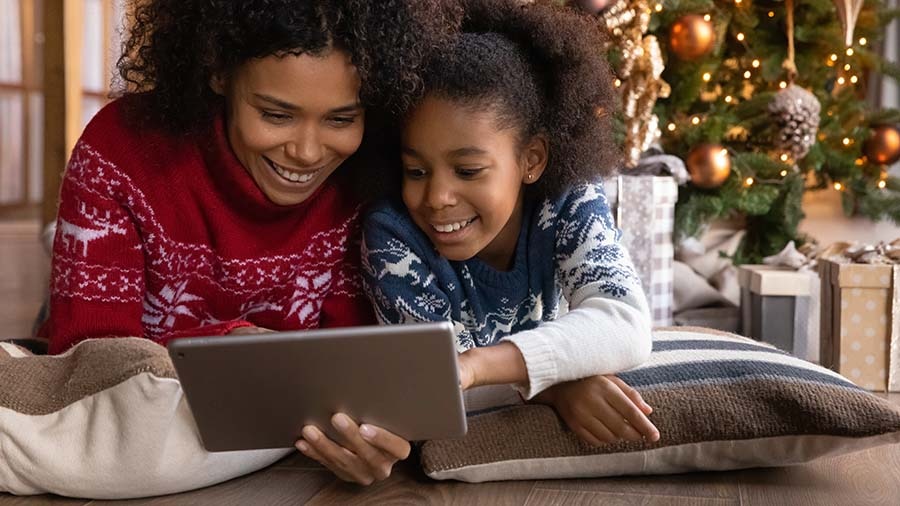 Mother and child holiday shopping on a tablet