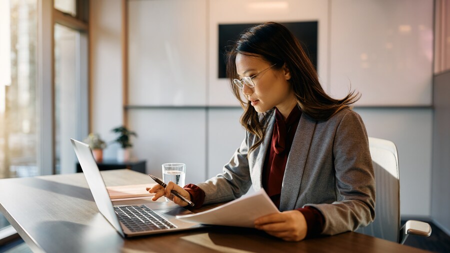 A person sitting at a desk with a laptop.