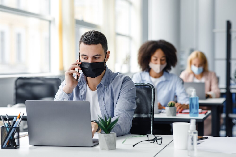Workers in office wearing masks