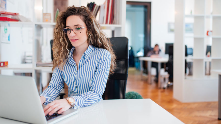 A person sitting at a desk with a laptop.