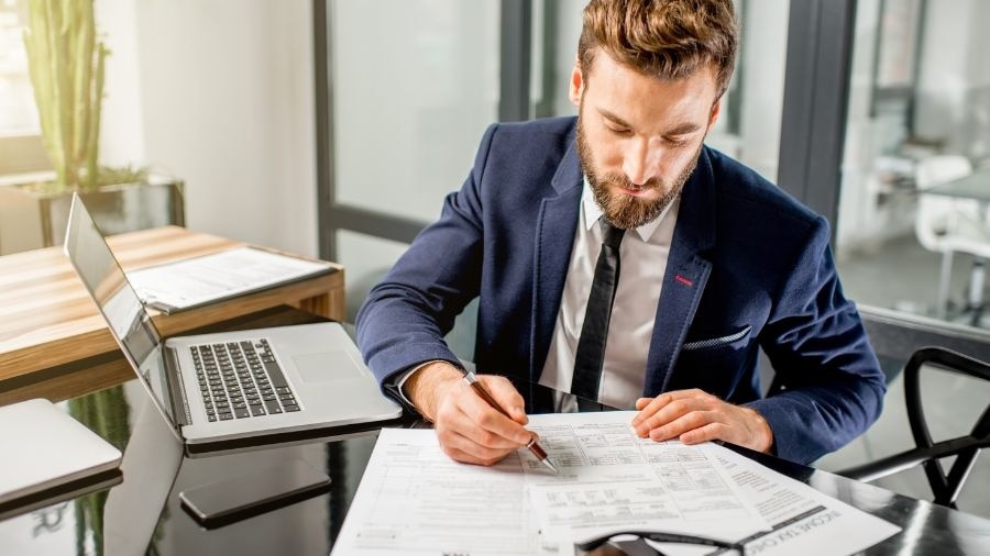 A person sitting at a desk with a laptop.