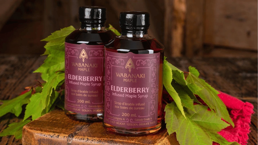 Two bottles of elderberry infused maple syrup
