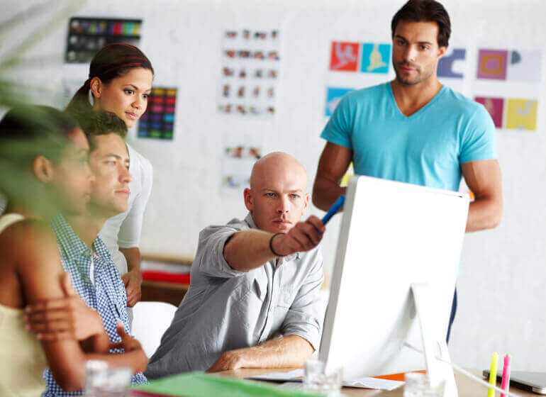 People gathering in office discussing a project