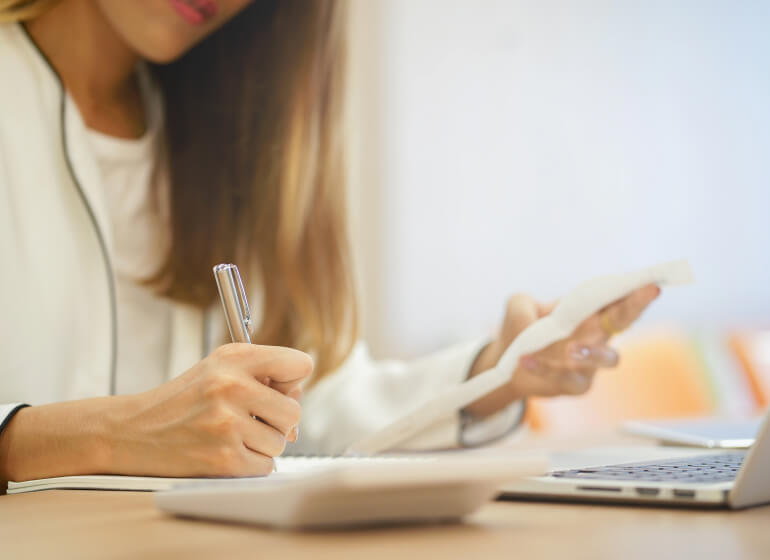 Woman writing on a notepad.