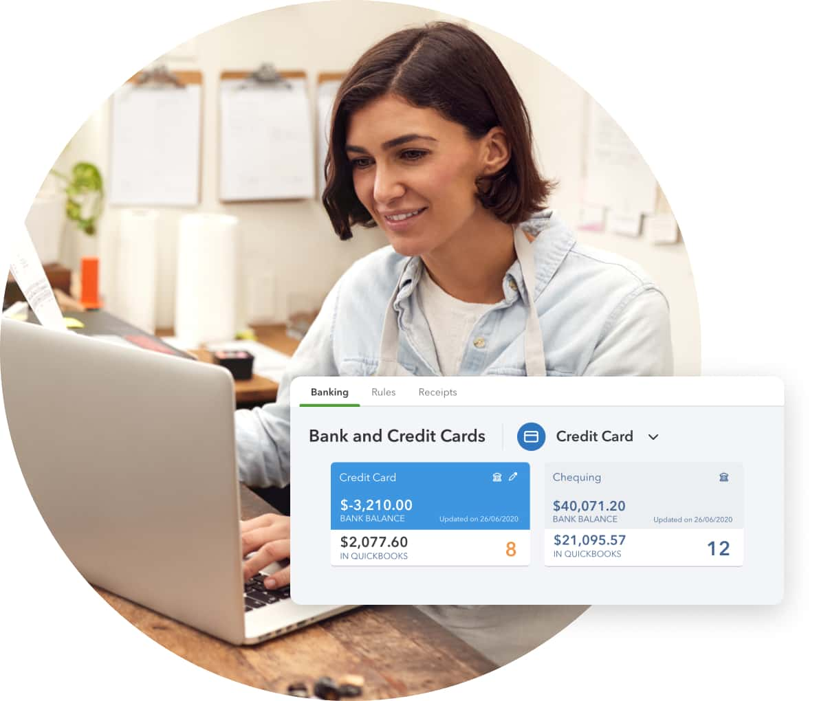 Smiling woman looking at laptop with bank and credit card product screen