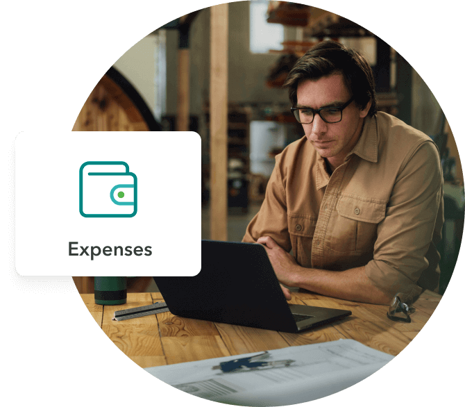 Small business man using laptop check expenses.