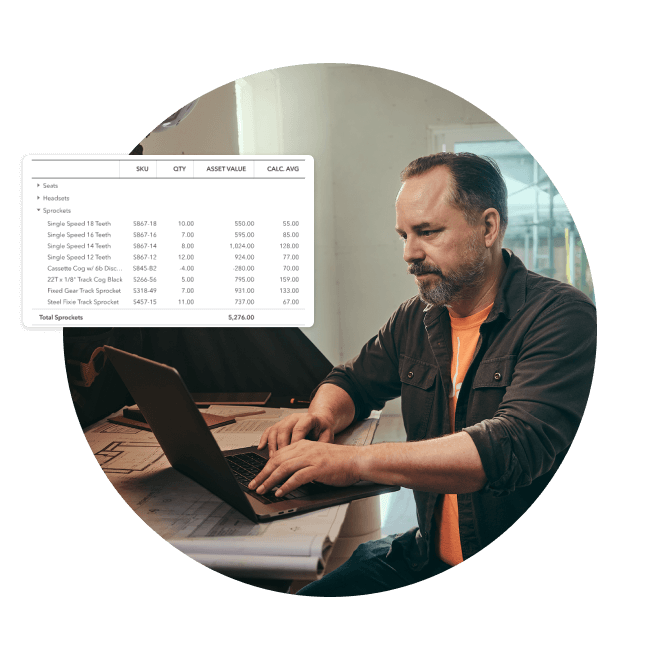 A man sitting at his laptop with QuickBooks Online overlay of a spreadsheet