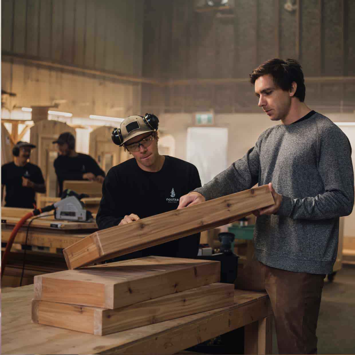 Two men doing carpentry works