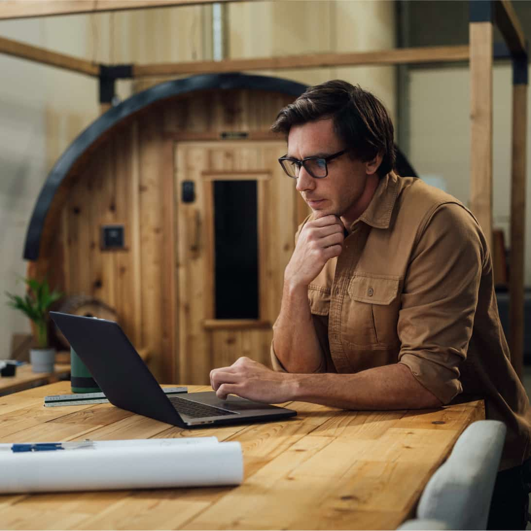 A person sitting at a table with a laptop.