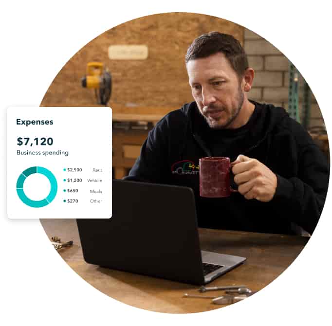 Man checking expenses through laptop with a coffee in hand.