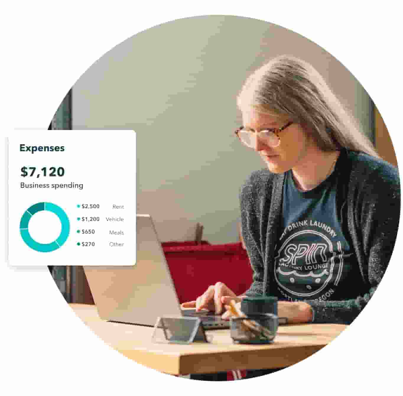 Woman intensely focused on laptop, checking expenses in QuickBooks.
