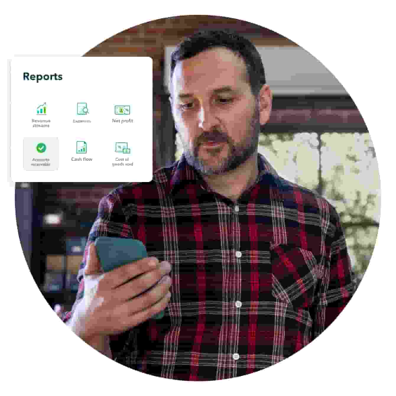 A man in a plaid shirt checks QuickBooks on his work phone, and looks at available reports.