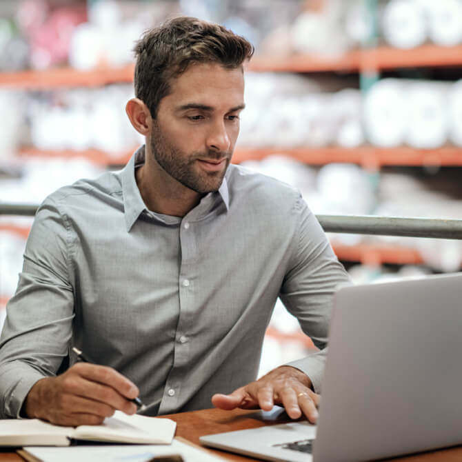 A person sitting at a table with a laptop.