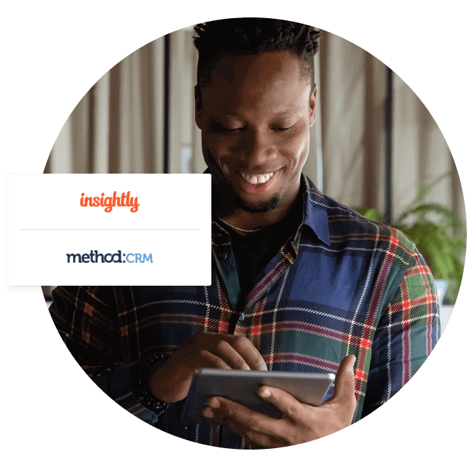 A man smiles while looking at a tablet. A pop-up shows the Insightly and Method:CRM app logos.