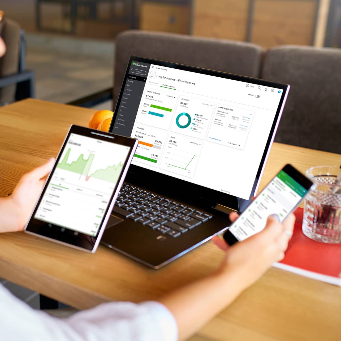 A laptop, tablet, and smartphone showing QuickBooks Online dashboards.