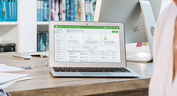Laptop screen showing QuickBooks Online dashboard