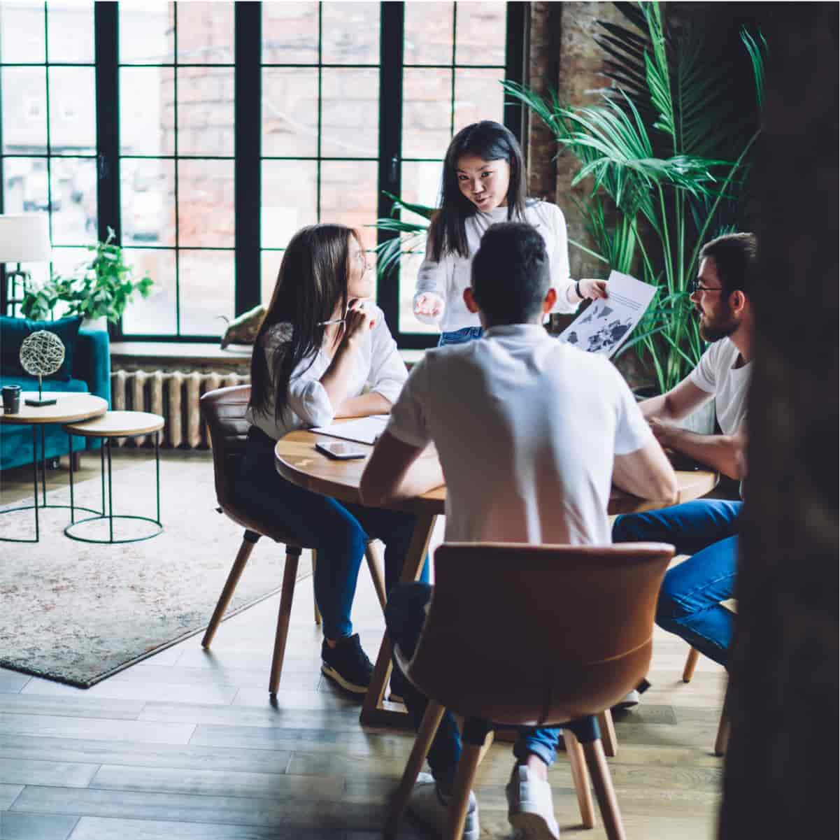 A group of people sitting around a table.