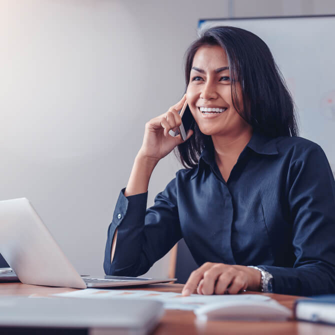 A person sitting at a desk with a laptop.