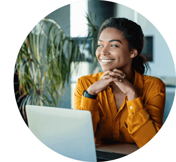 A financial advisor with hands under chin smiles as she looks to the future. 