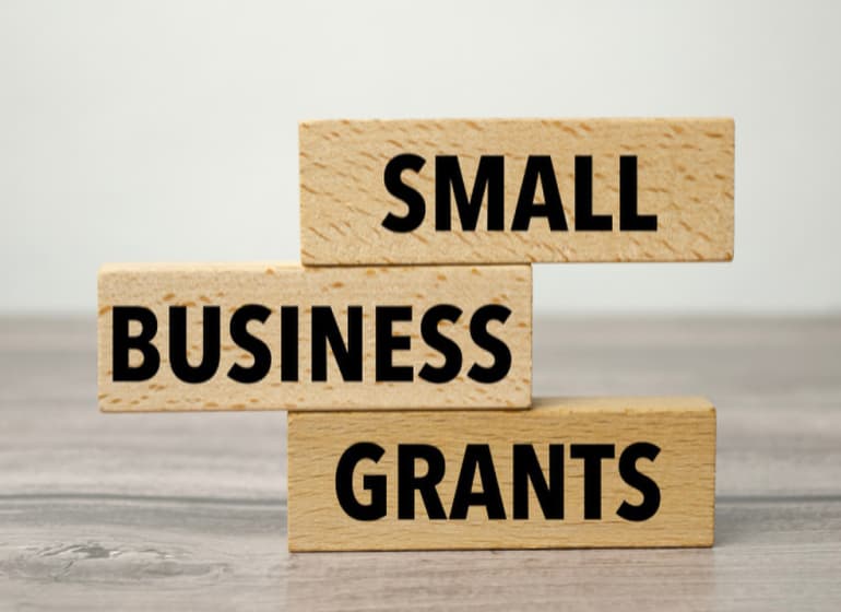 Stacked wooden blocks spelling out Small Business Grants