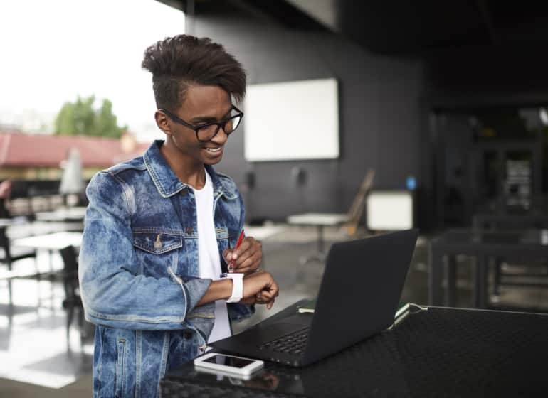 A business owner works from an outdoor table.