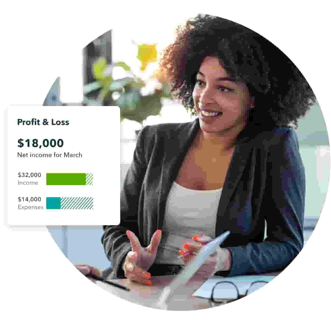 A smiling woman in a dark grey blazer explains the value of QuickBooks to a client. 