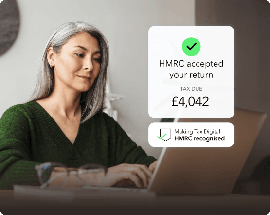 A person wearing a black hat with a banana in it.