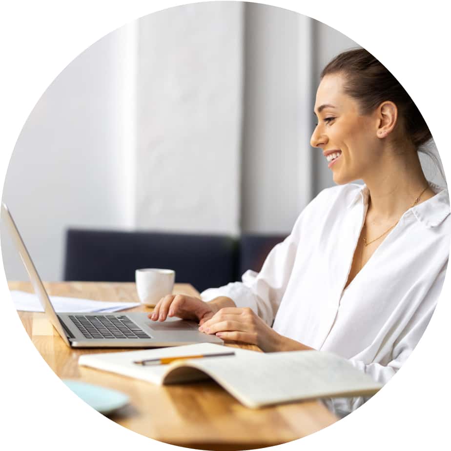 A person sitting at a desk with a laptop computer.