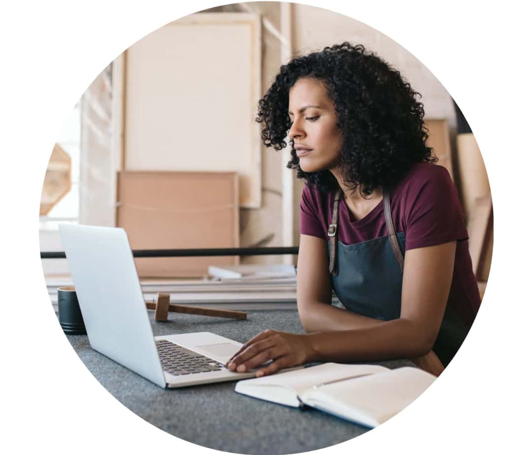 A person sitting at a desk with a laptop.