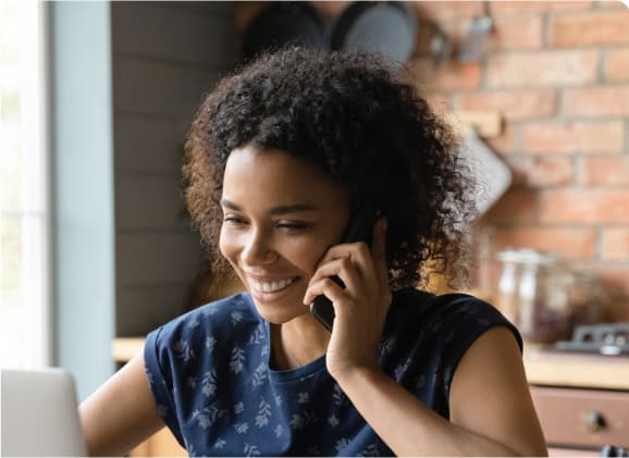 A person talking on a cell phone while sitting down.