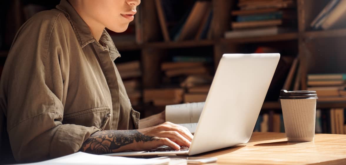 A person is typing on a laptop computer.