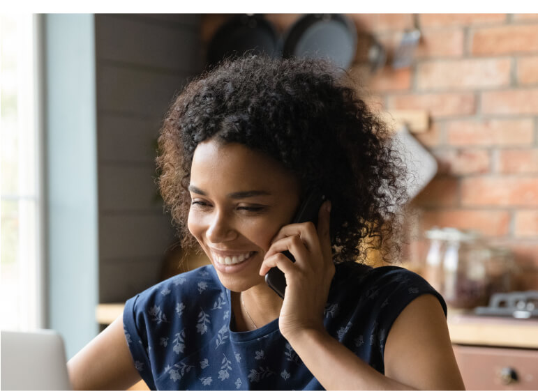 A person talking on a cell phone while sitting down.