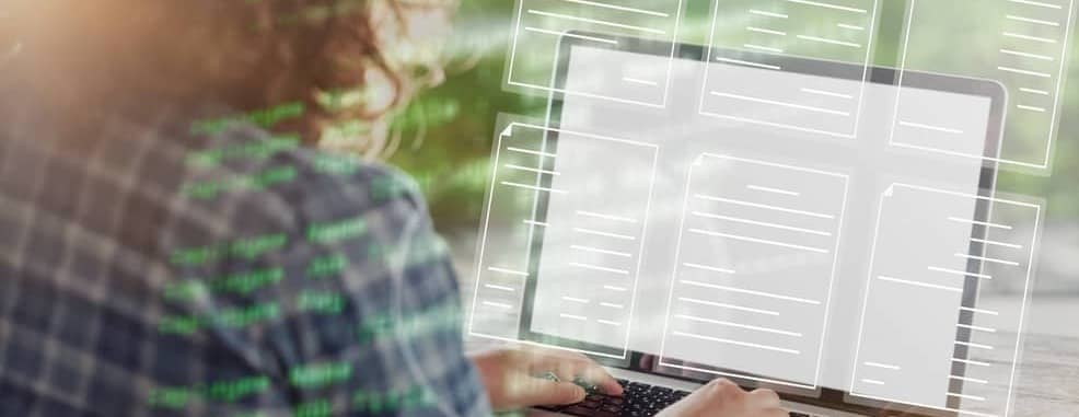 A person typing on a laptop computer.