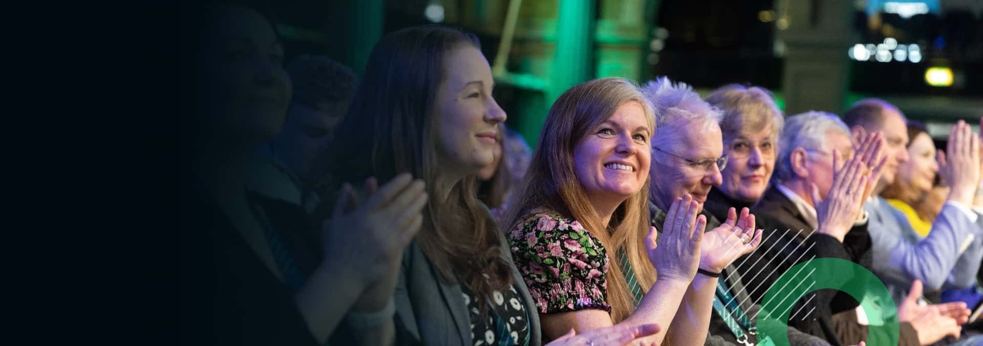 A person holding a cup with a smile on her face.