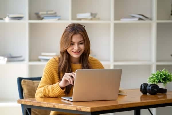 A person sitting at a desk with a laptop computer.