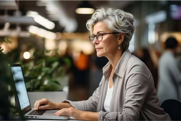 A person sitting at a desk with a laptop.