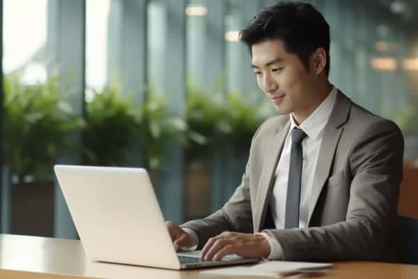 A person sitting at a desk with a laptop computer.