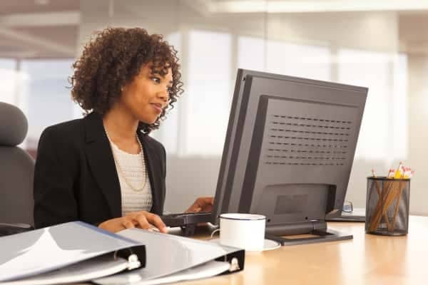 A person sitting at a desk with a laptop.